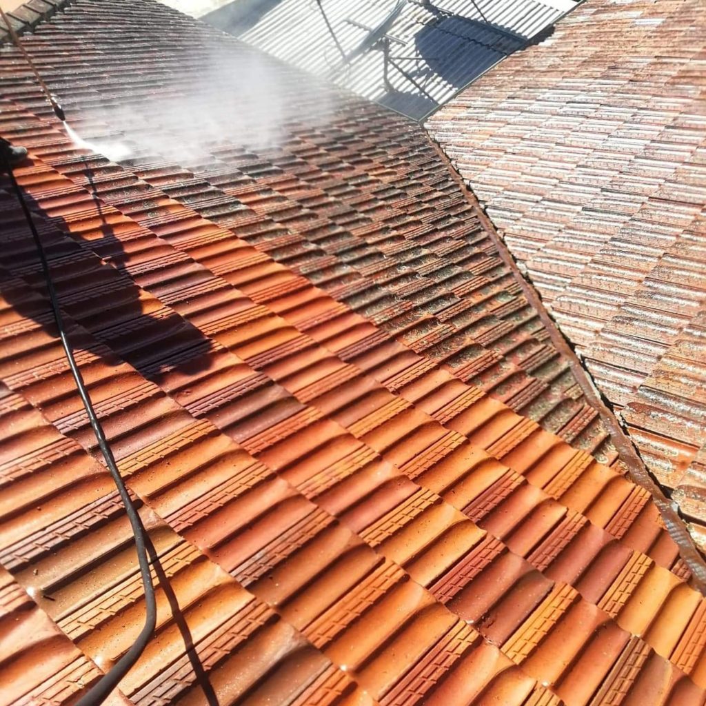 clean roof tiles after washing and dirty roof tiles being washed